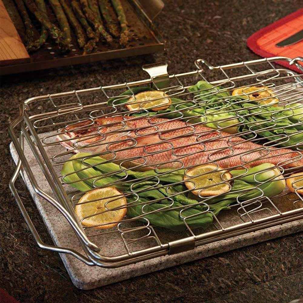 Flexible grill basket holding mixed vegetables on a grill surface
