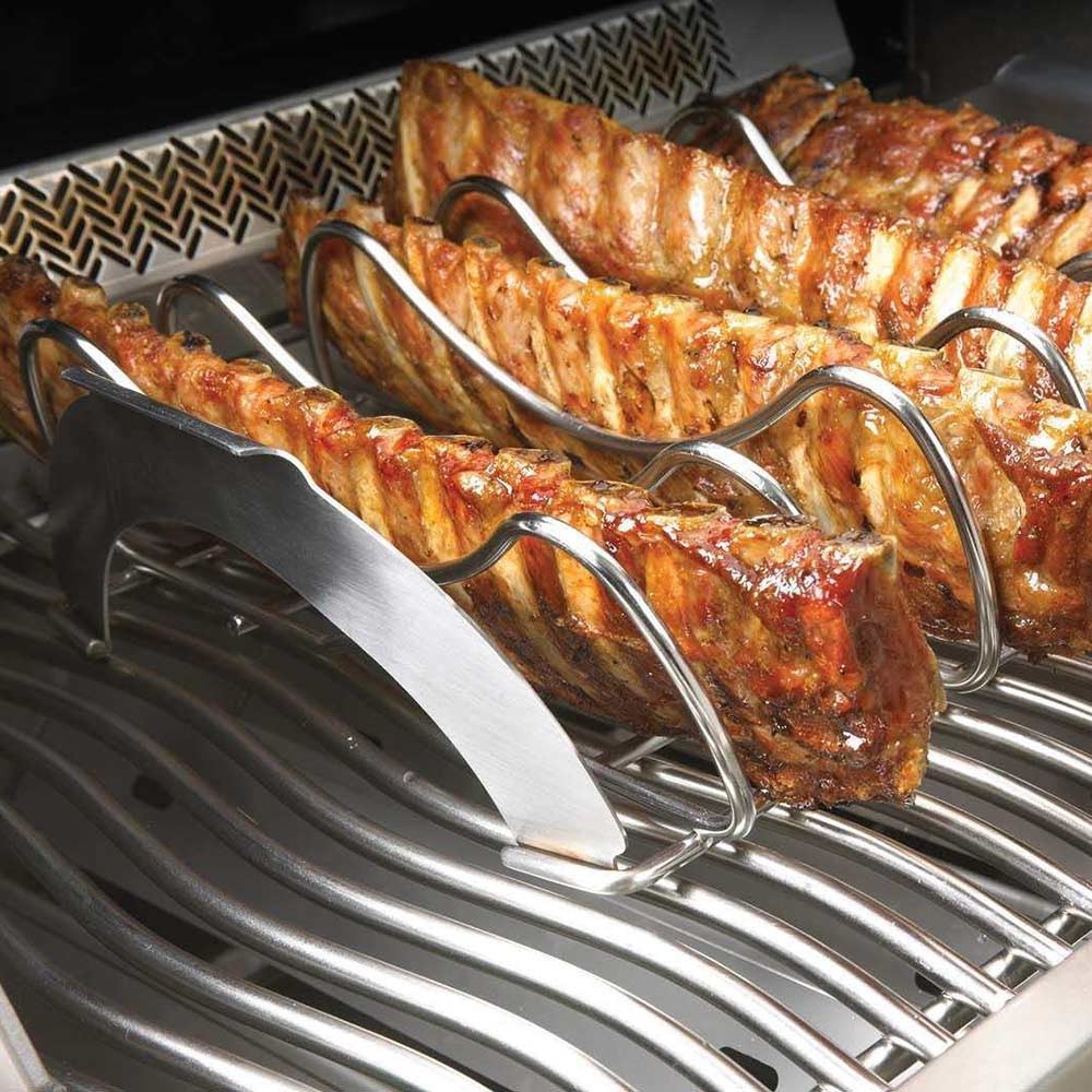 Rib roasting rack with multiple ribs on a grill grate