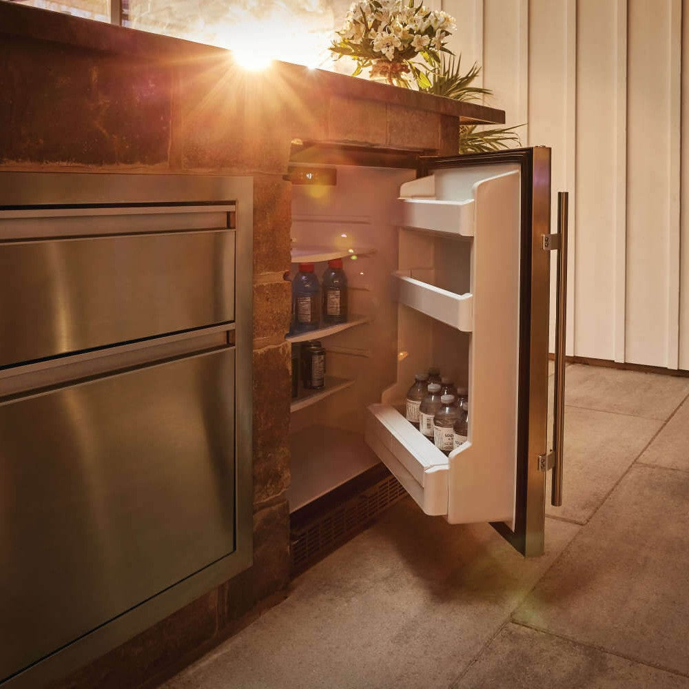 Outdoor refrigerator with open door showing white shelves and bottle compartments
