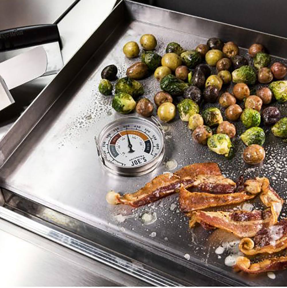 Oklahoma Joe's round temperature gauge on grill tray, dial marked for BBQ and grill heat