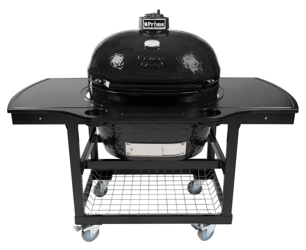 Oval ceramic charcoal kamado grill on wheeled cart with side shelves and lower cooking grate