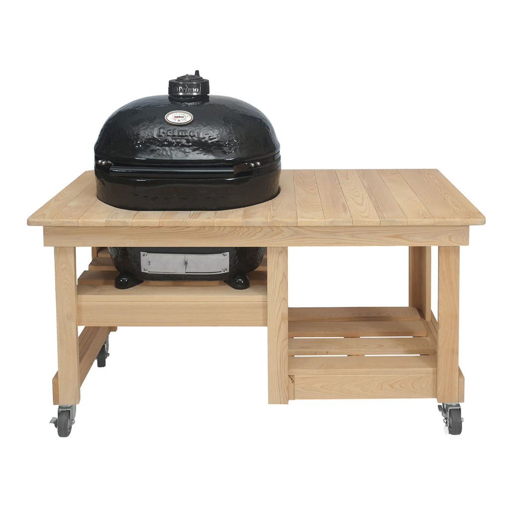 Large oval ceramic kamado grill on cypress countertop table with lid closed