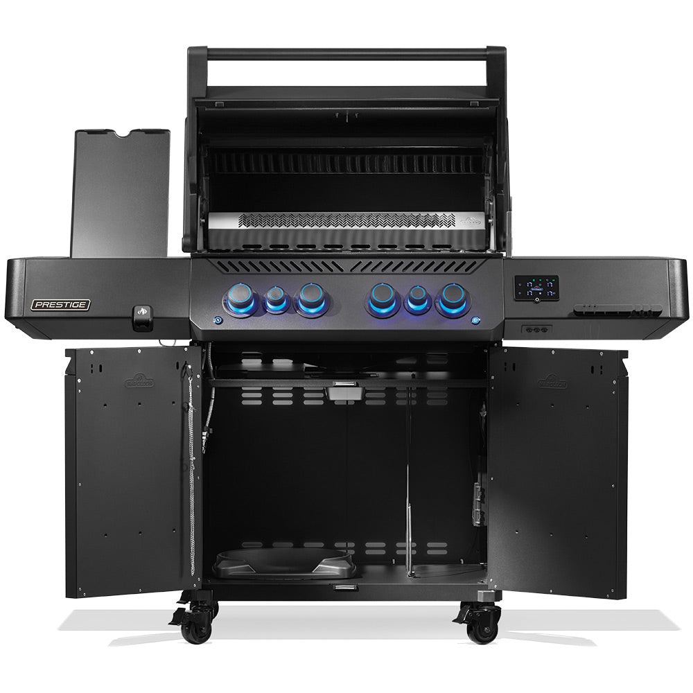 Napoleon Prestige 500 gas grill with open lid, cooking grates, and side shelves