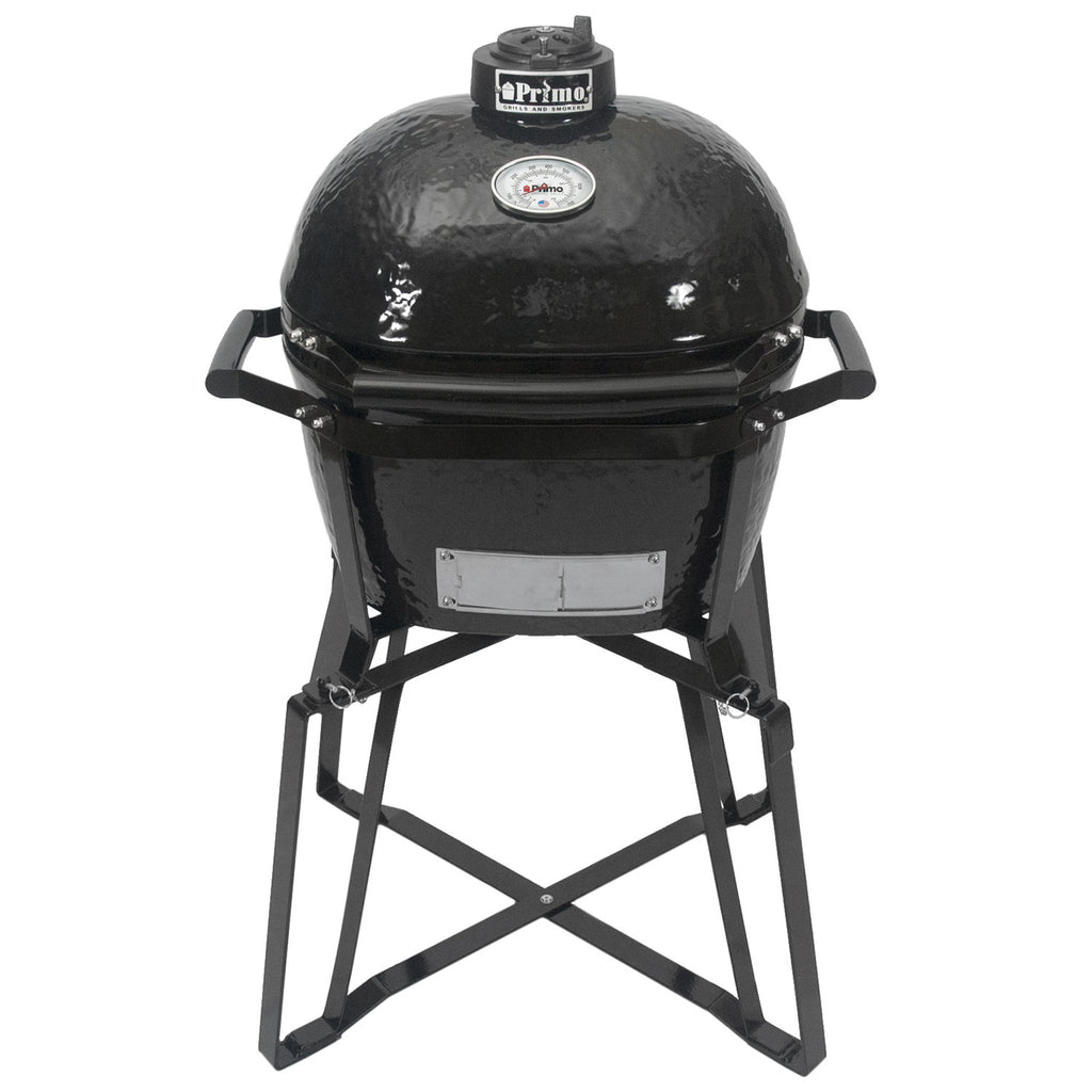 Junior oval ceramic kamado grill in charcoal with lid, handles, and metal stand.