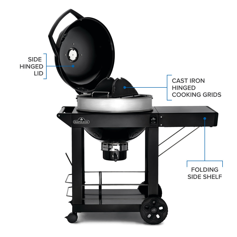 Charcoal kettle grill with open lid and folding side shelf, black cart and silver bowl