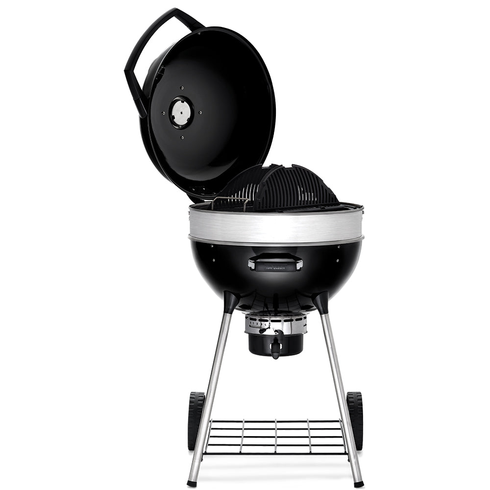 Charcoal kettle grill with open dome lid, firebox and cooking grate on tripod legs