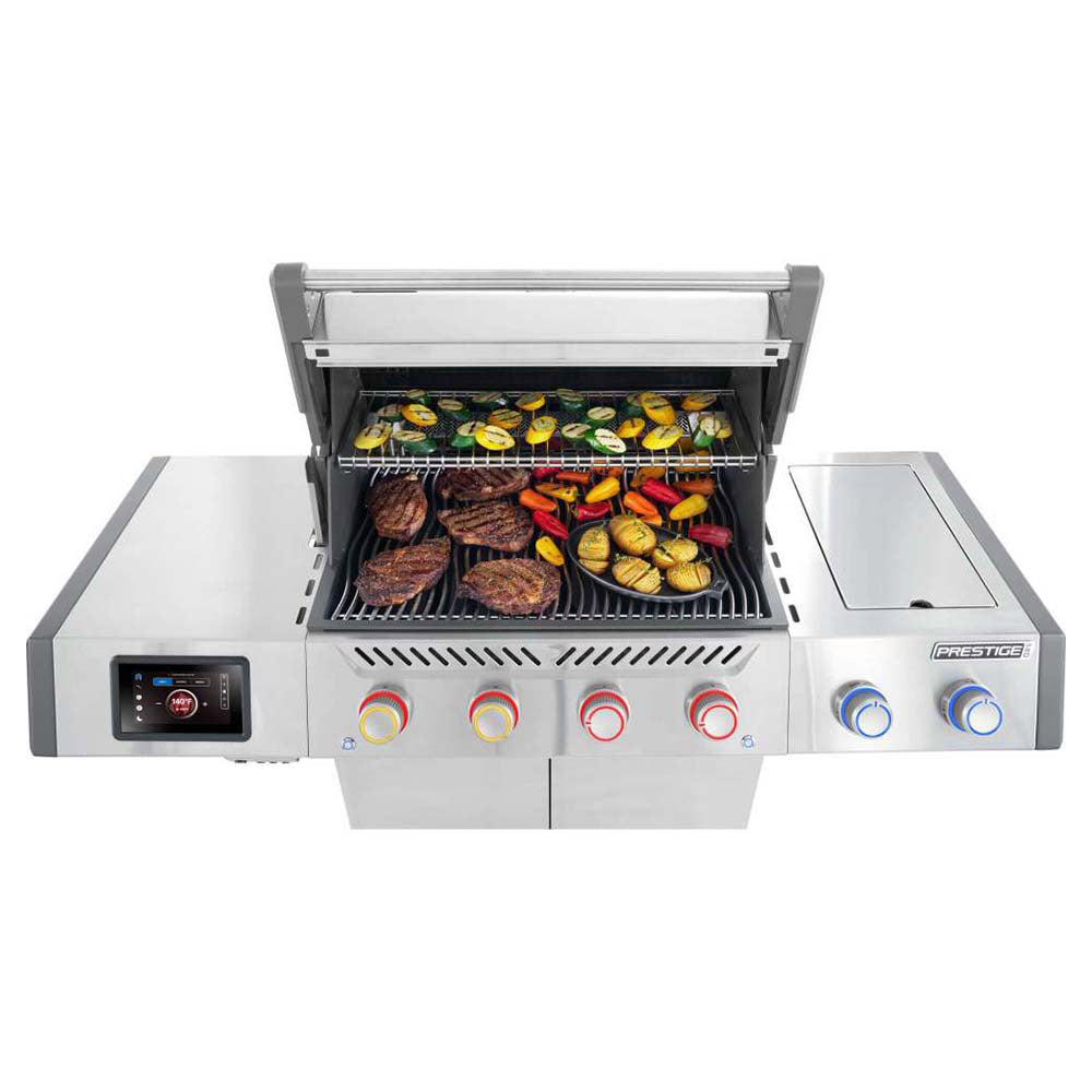 Open stainless steel gas grill with food on cooking grates and front control knobs