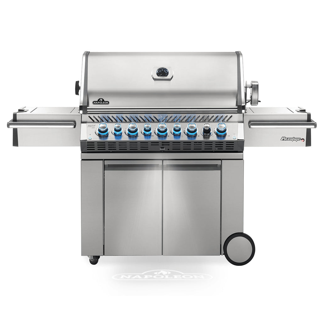 Stainless gas grill on cart with control knobs and side shelves