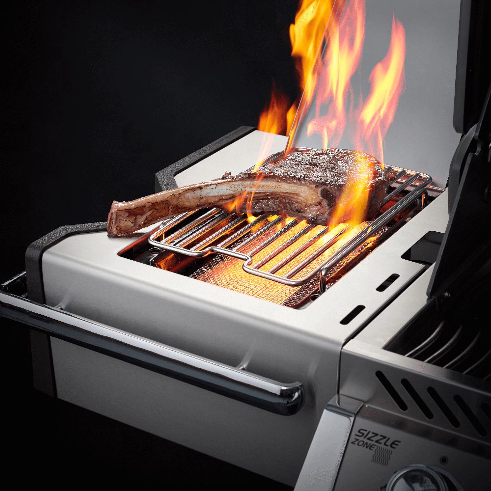 Gas grill cooking grate with burning wood and active flames
