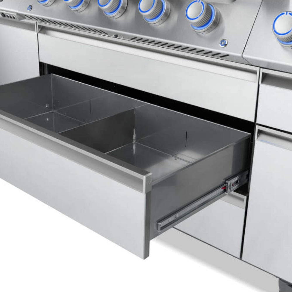 Gas grill with open lower storage drawer and grease tray beneath burner controls