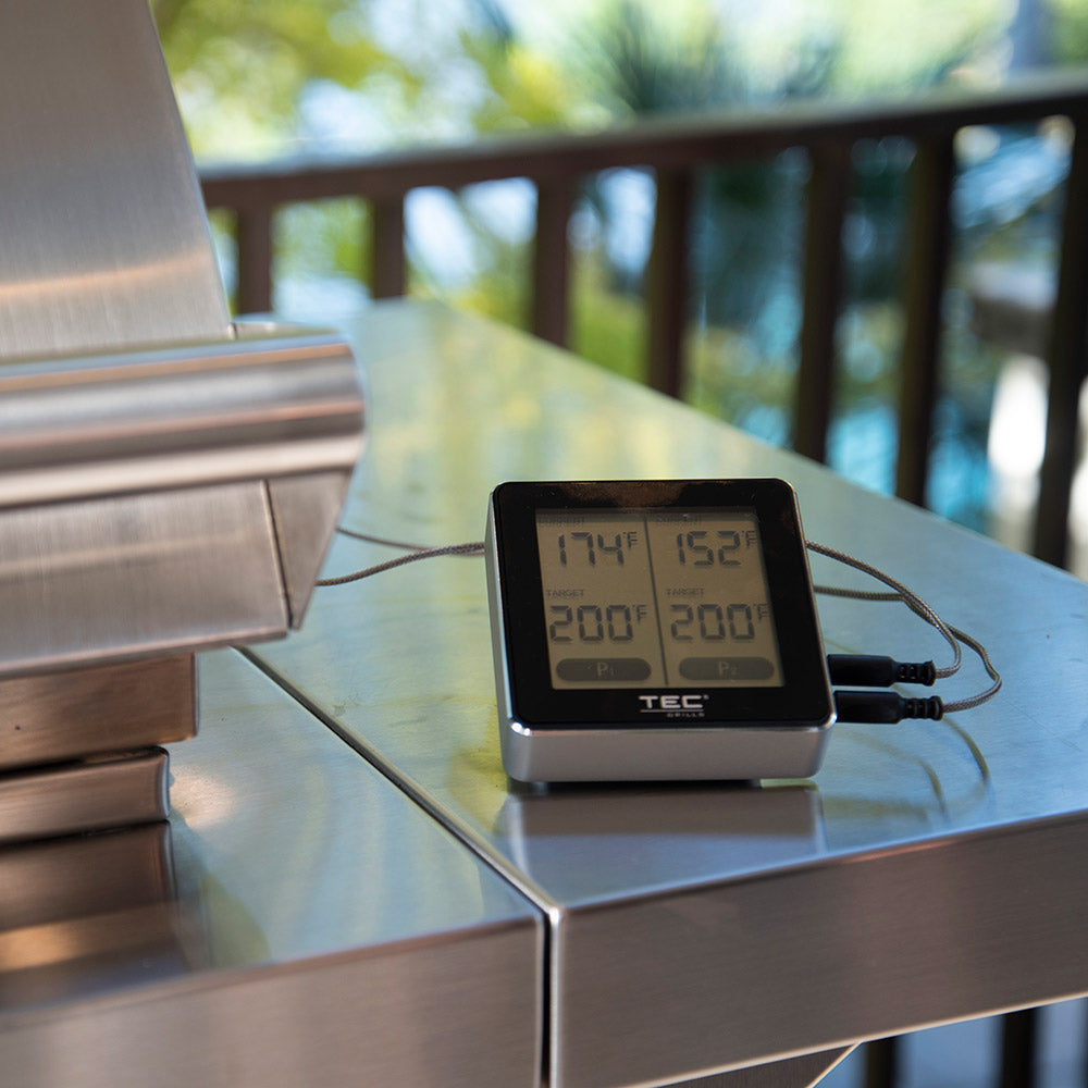 Wireless meat thermometer with dual reading display on stand and connected probe wires