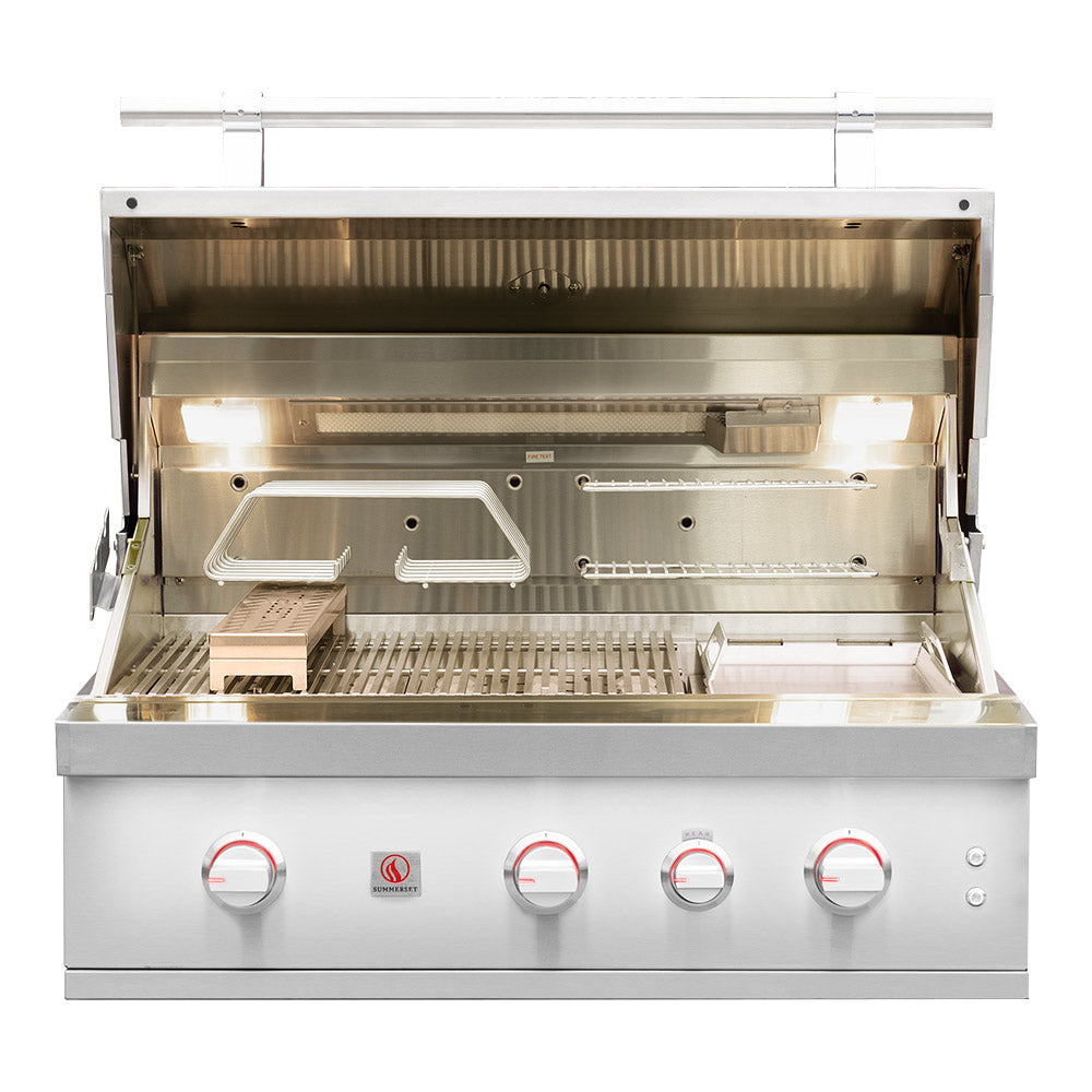 Built-in gas grill with open hood, stainless burners, and cooking grates.