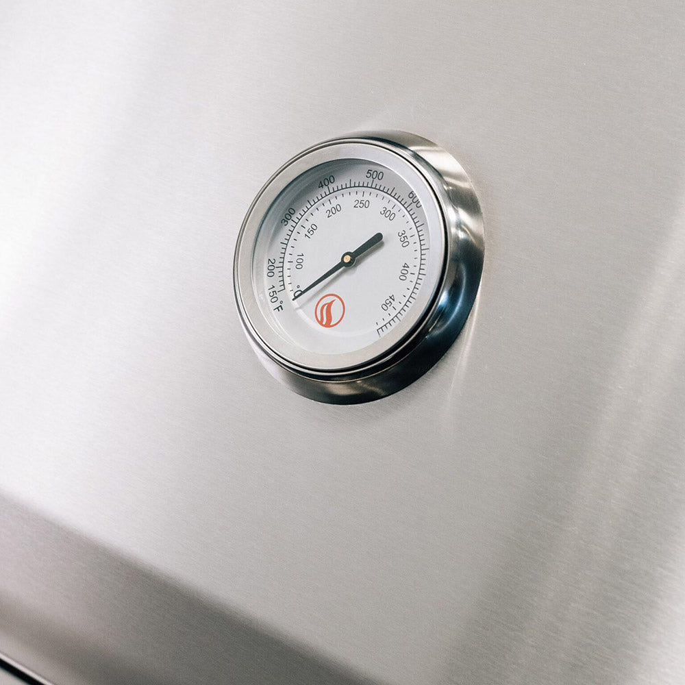 Stainless gas grill thermometer on the front panel with temperature markings