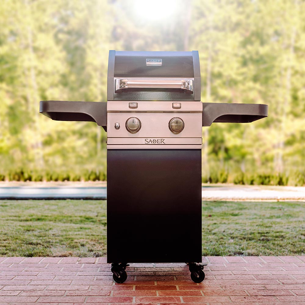 Black infrared freestanding grill with side shelves, front control knobs, and closed lid