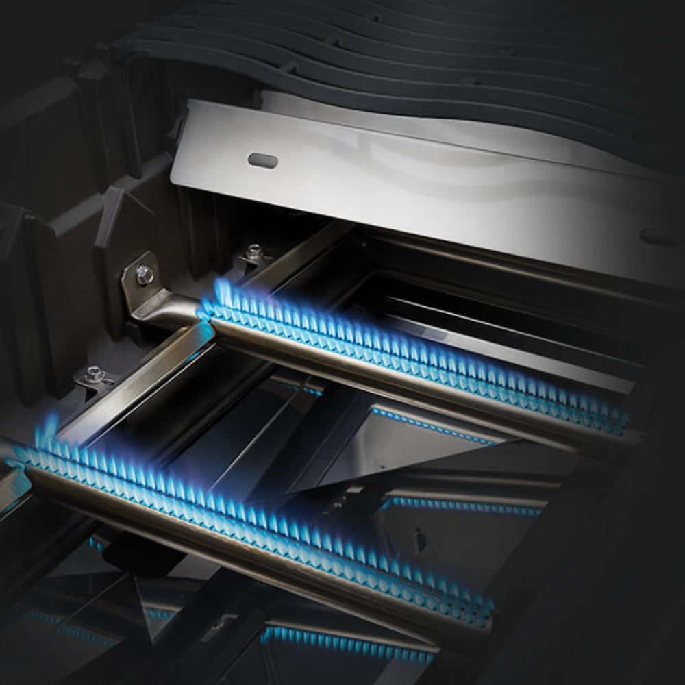 Infrared-style burner tube lights inside the grill hood on a dark interior