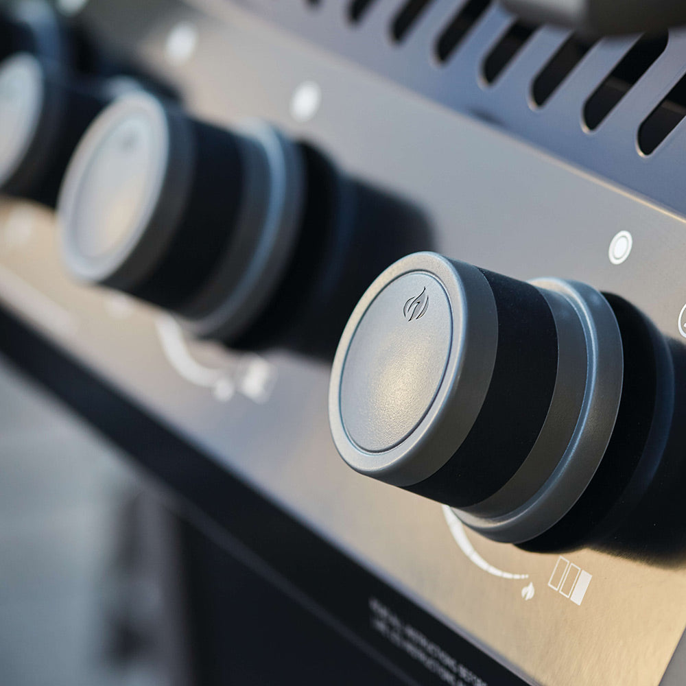 Gas grill control knob on black panel with power-style icon