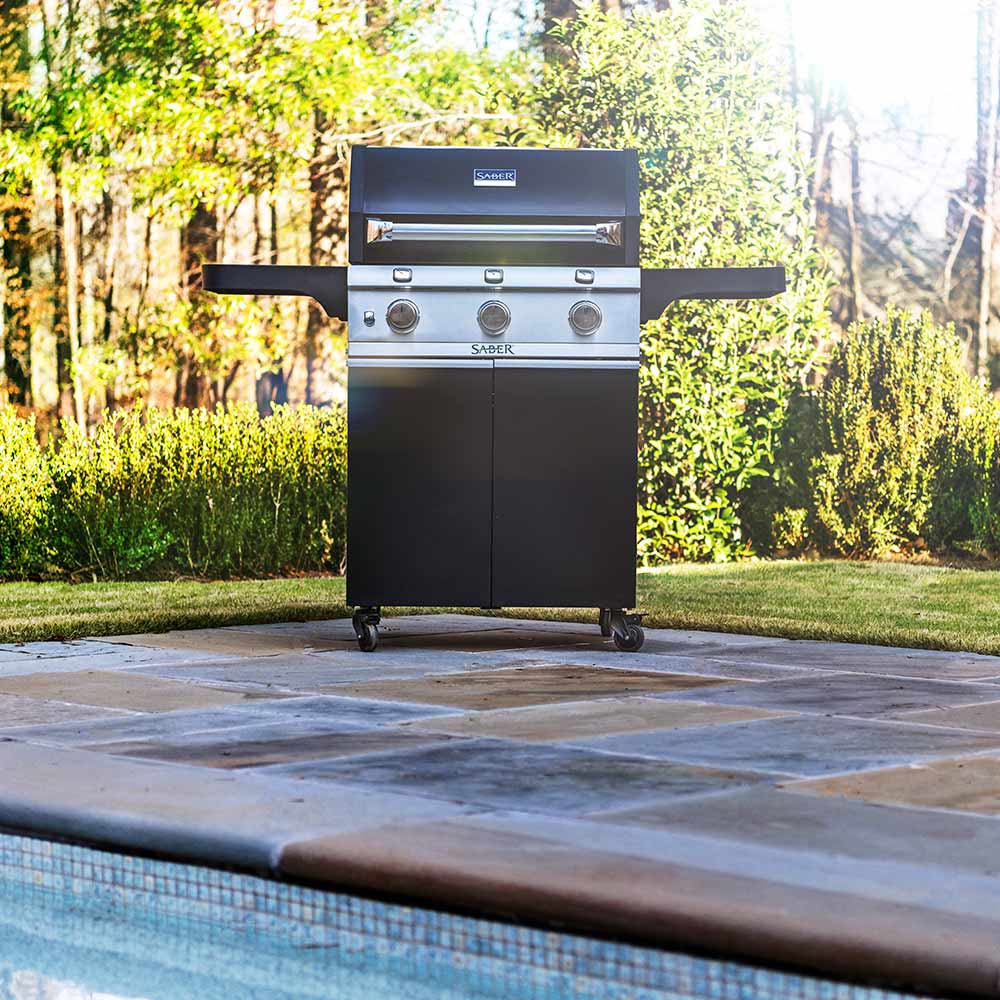 Black freestanding infrared grill with stainless lid, side shelves, and control knobs