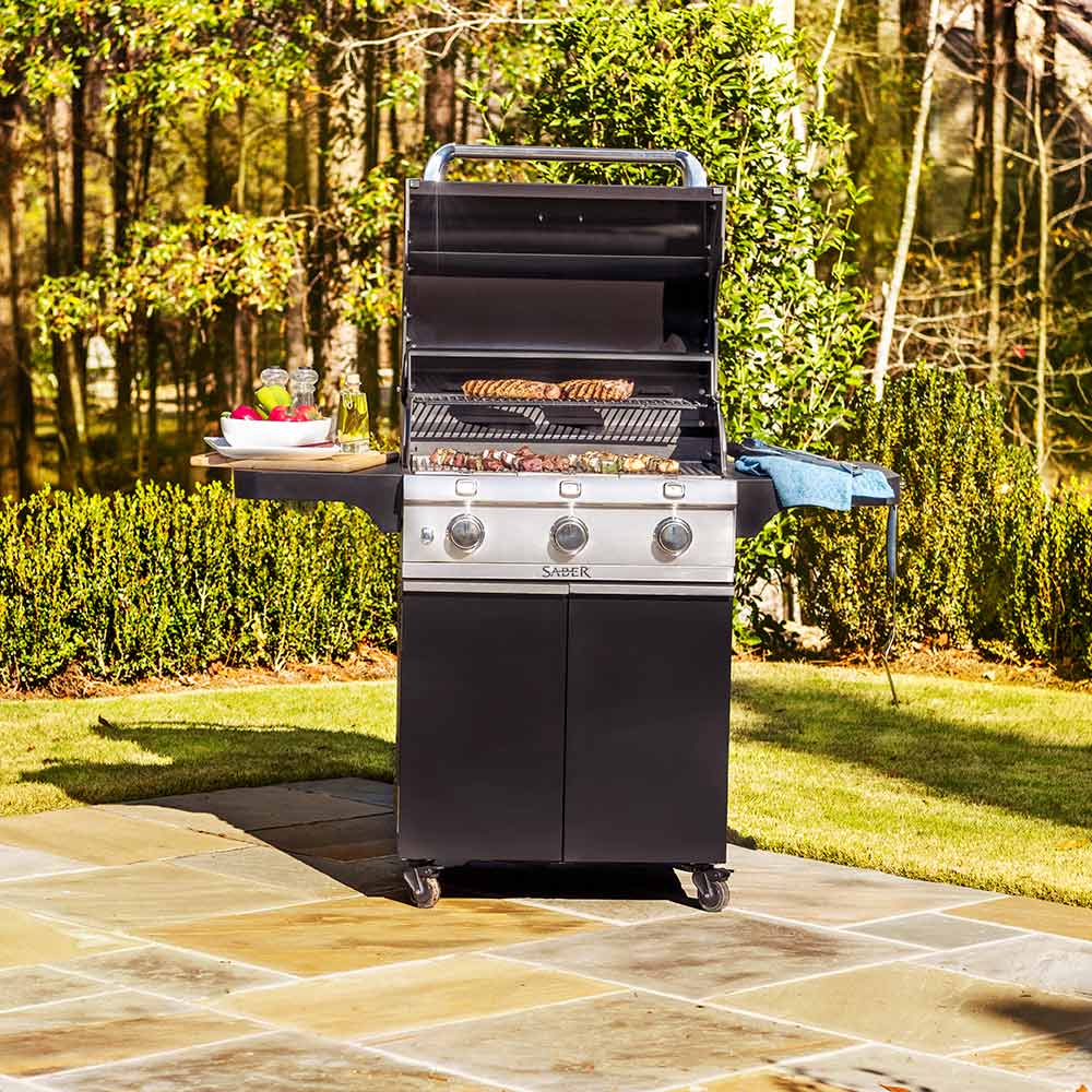 Black 3-burner grill with lid closed, stainless face, and front control knobs