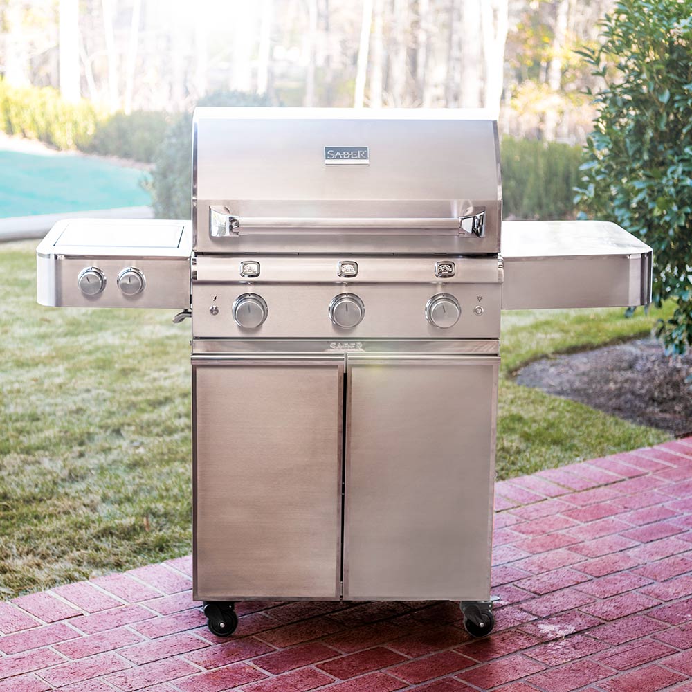Stainless steel infrared gas grill with closed hood, side cabinet doors, and front knobs