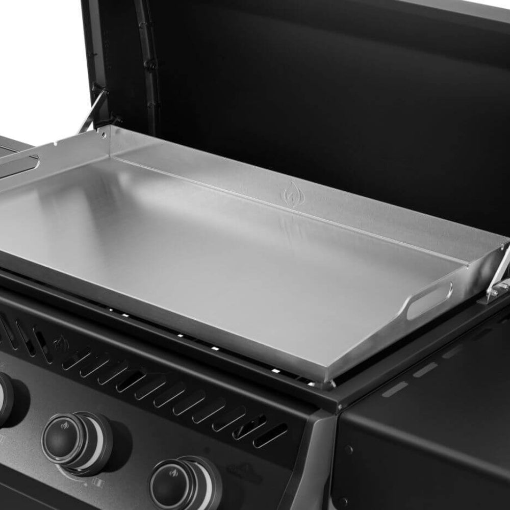 Stainless griddle drip tray inside open grill hood with front control knobs