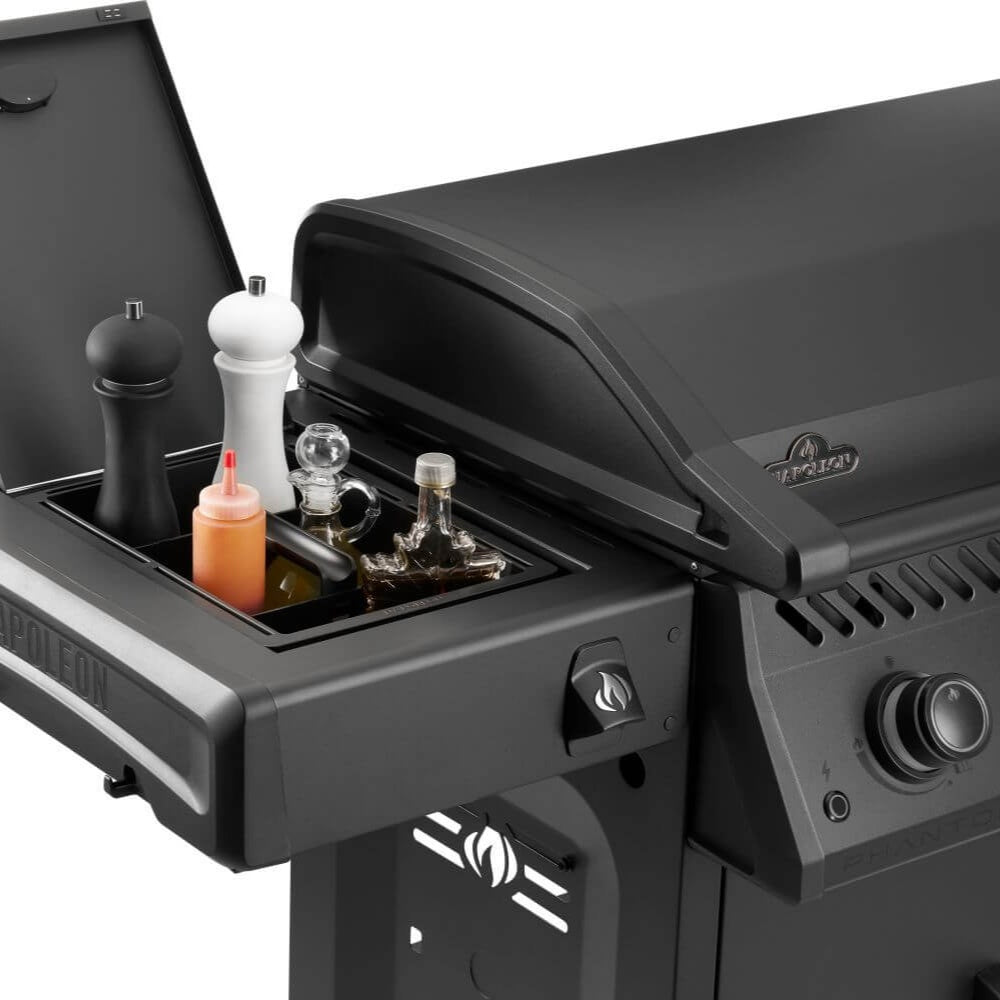 Gas griddle front-side accessory area with bottles and controls under lid