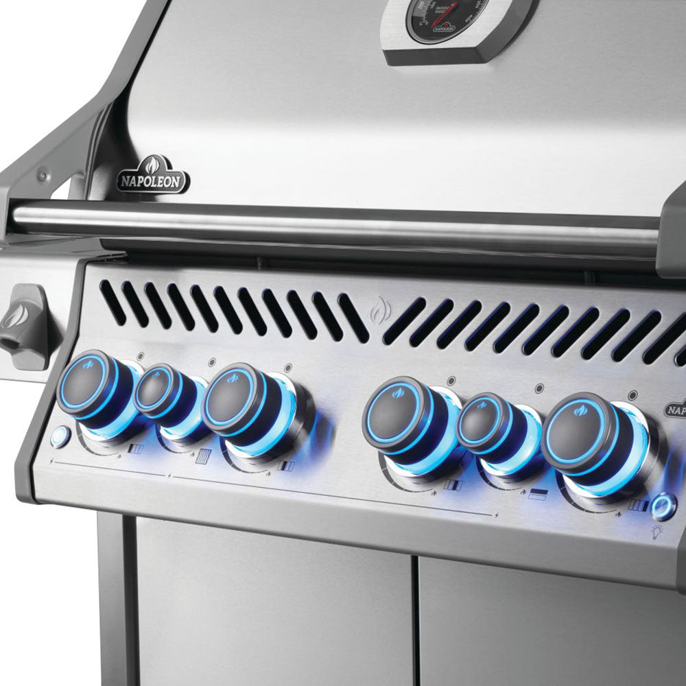 Gas grill front panel with blue control knobs and vented burner hood