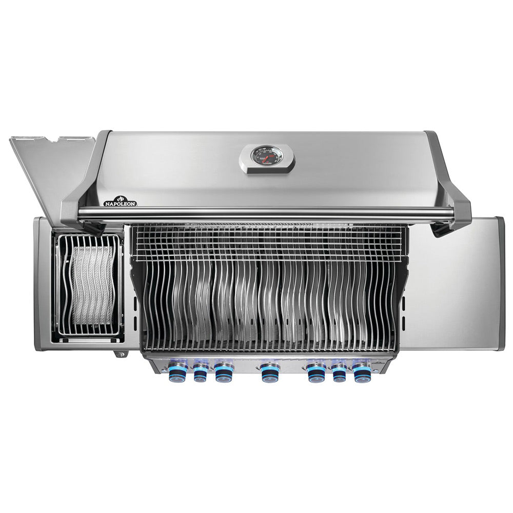 Stainless steel gas grill with open lid showing warming rack and burner tubes