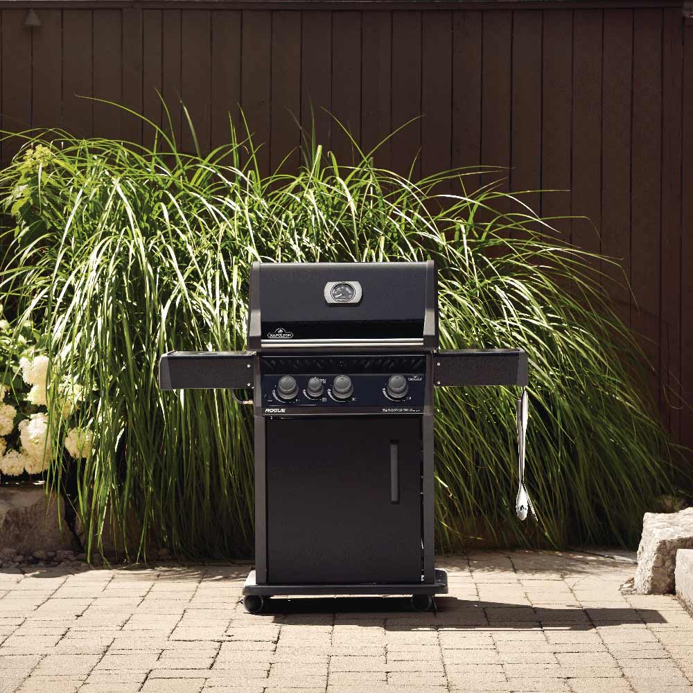 Black gas grill on cart with open lid and side shelves