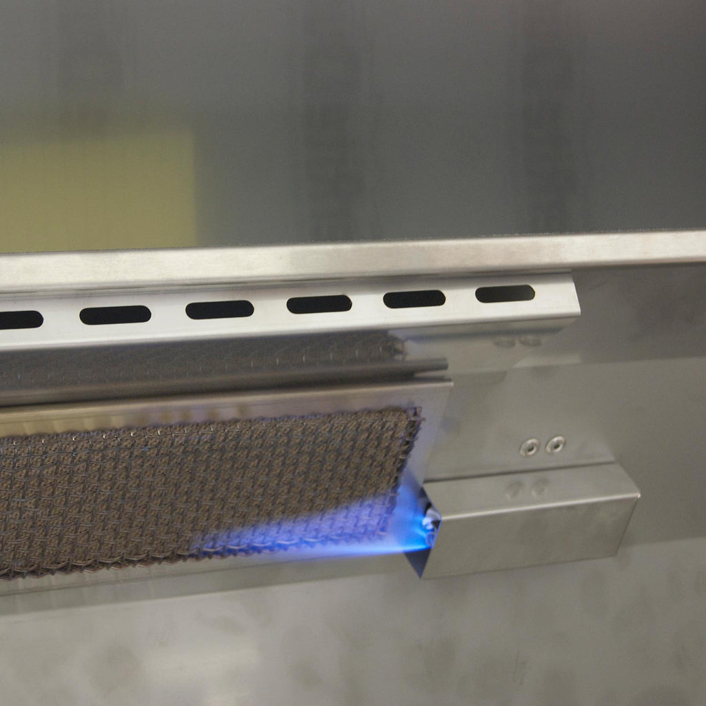 Lit grill burner area with visible blue flame under the cooking surface