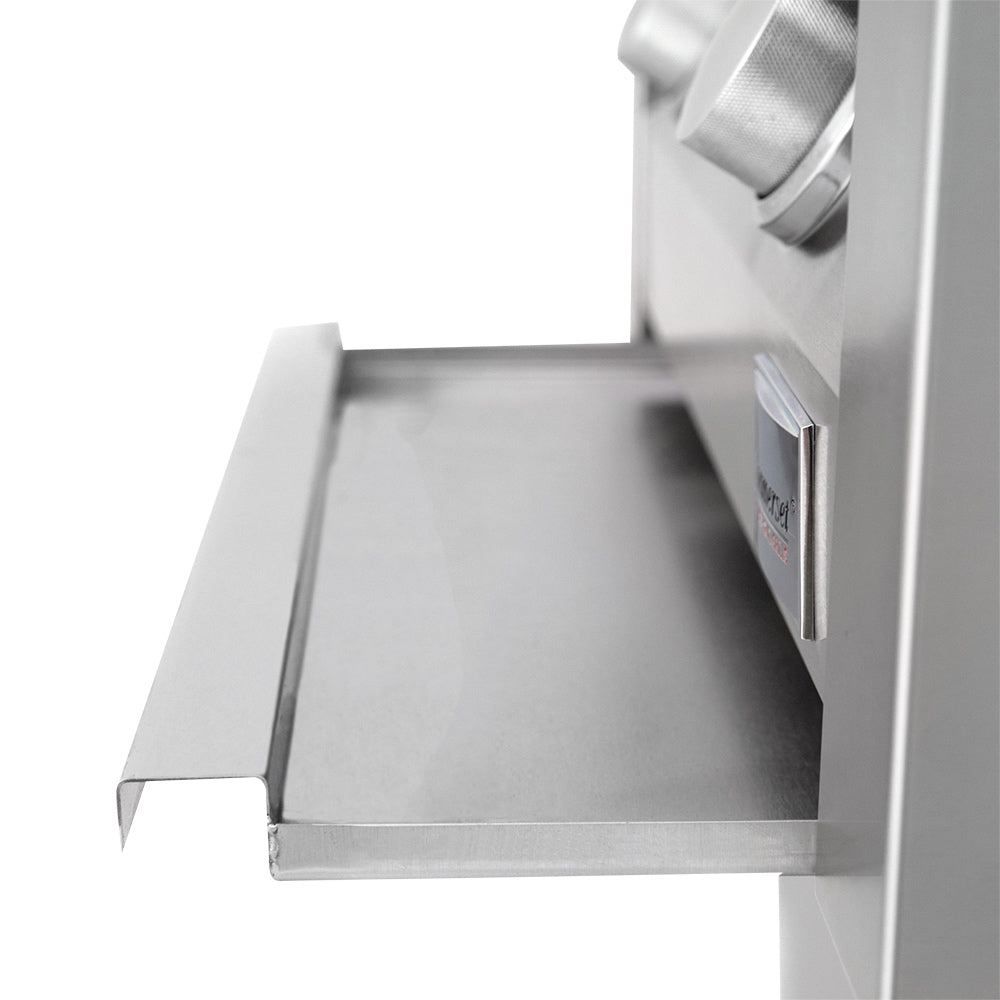 Built-in gas grill side shelf with stainless surface beside the open firebox