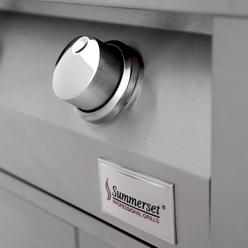 Built-in gas grill control knob and Summerset Professional Grills badge on stainless panel