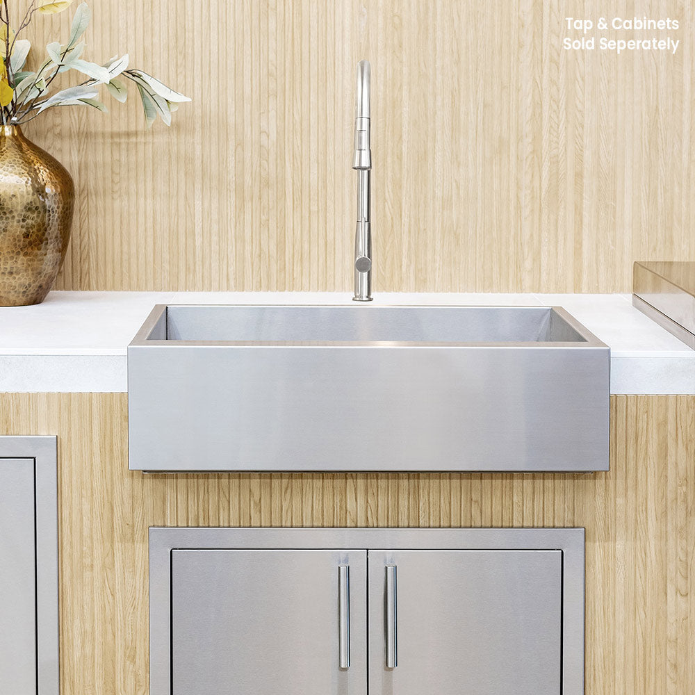 Stainless farmhouse outdoor sink basin front with wall-mounted faucet