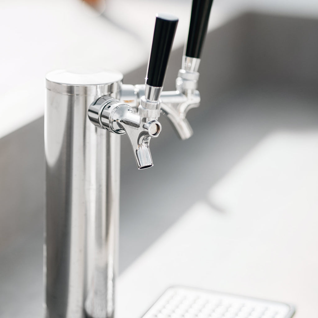 Stainless steel double keg tap with spigot valves and black handle grips