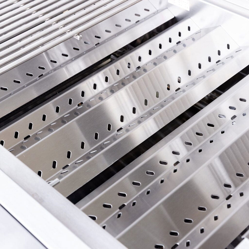 Freestanding gas grill interior with perforated flame tamers and metal cooking surface.