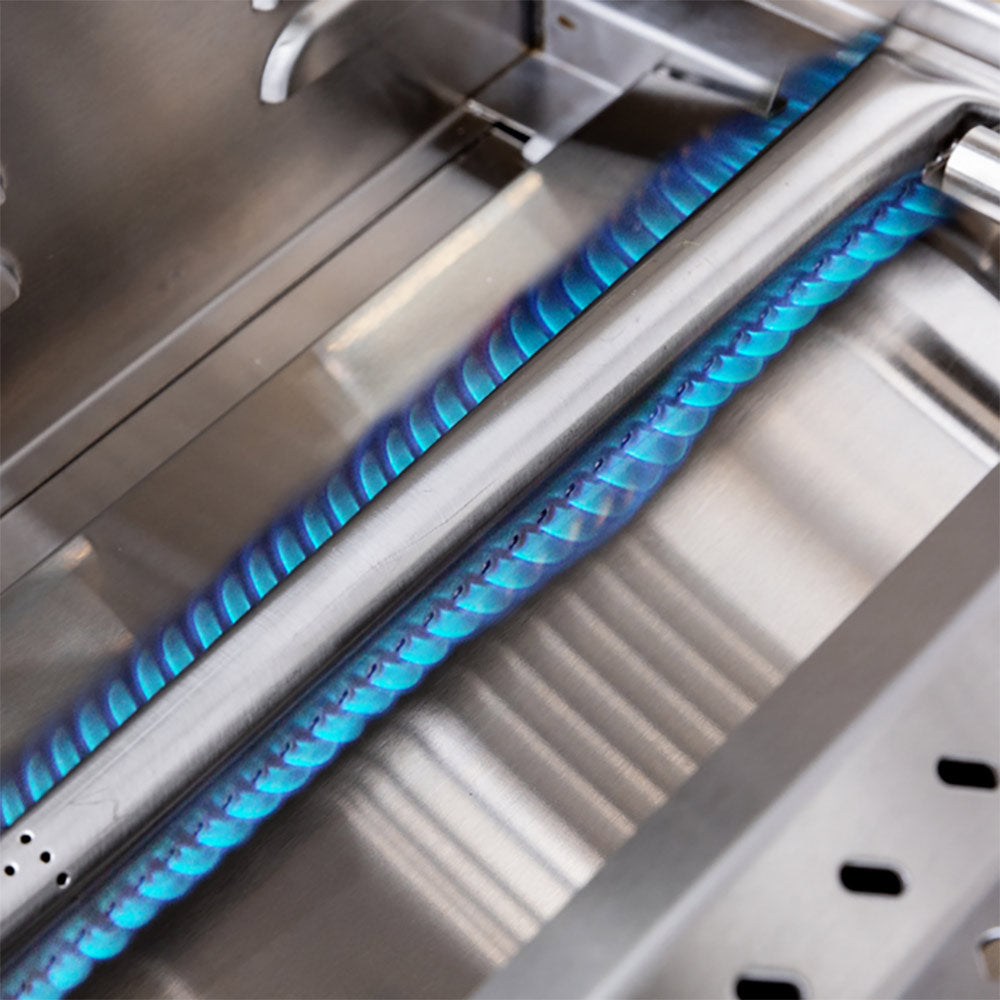 Gas grill burner with glowing blue flames under stainless firebox grates