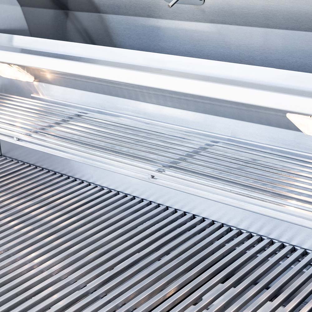Stainless cooking grids with closely spaced bars inside the grill hood