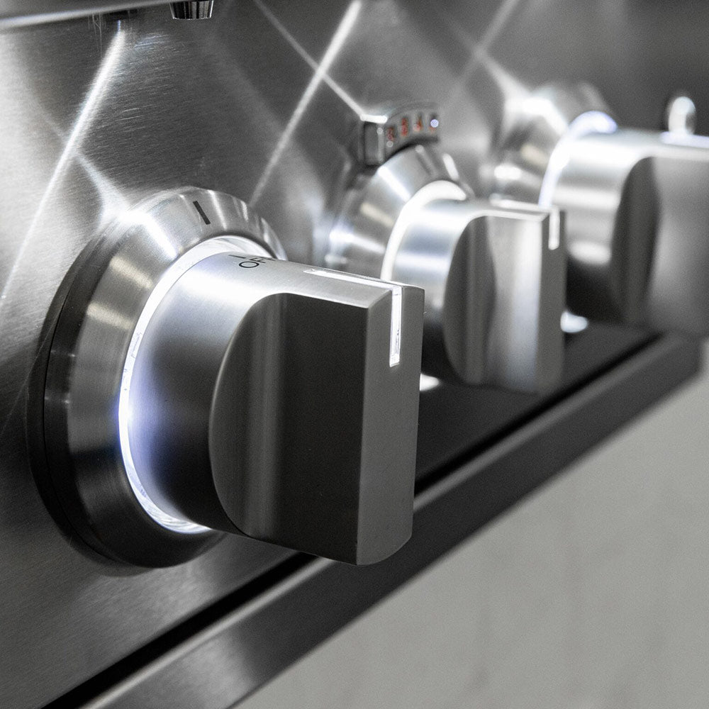 Stainless gas grill control knob on the front panel next to burner controls.
