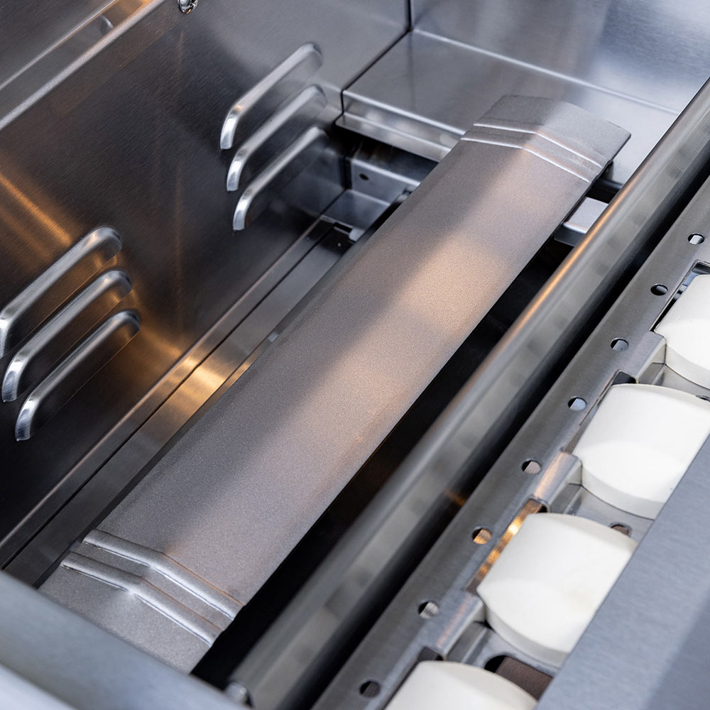 Stainless gas grill burner tubes and cooking grates inside the open grill