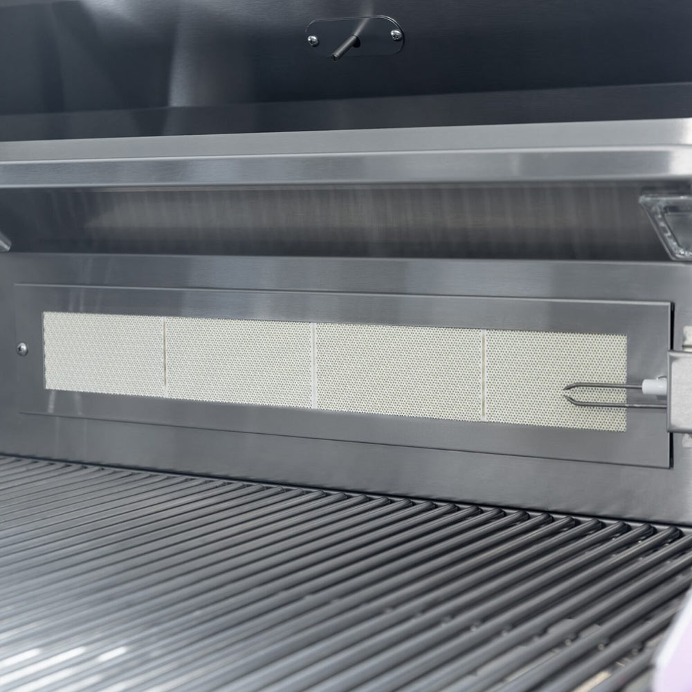 Stainless grill interior with heat shield above the cooking grates