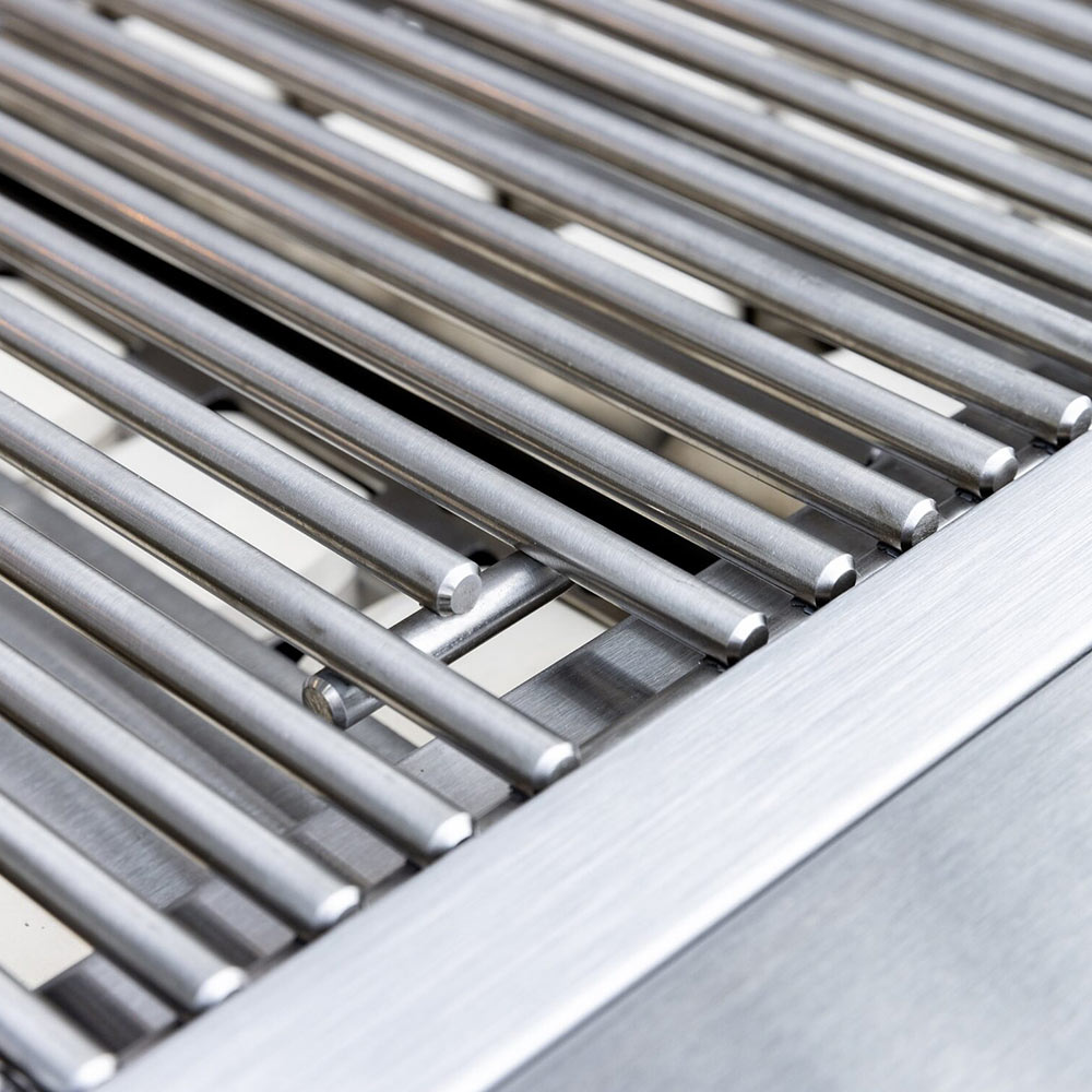 Stainless burner tubes under grill grates inside the built-in firebox