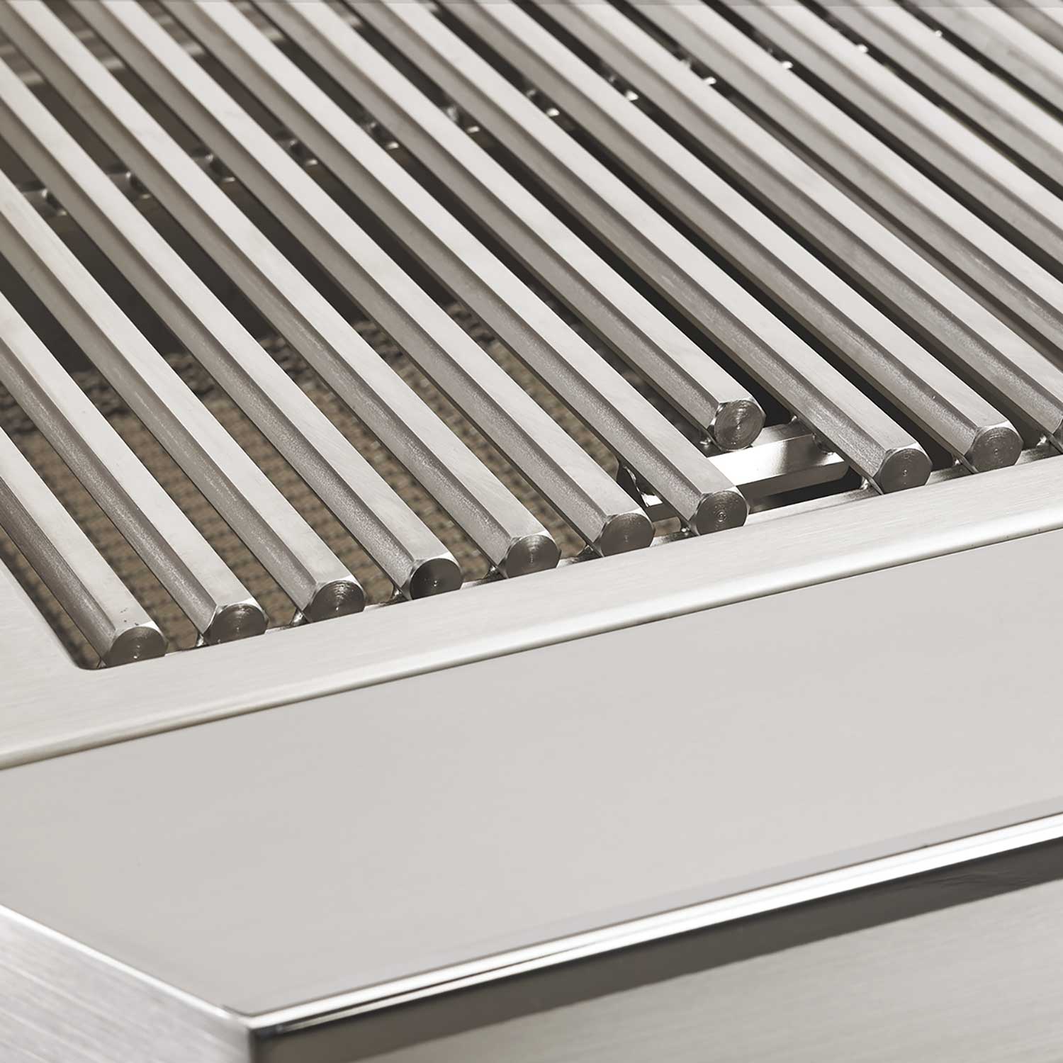 Stainless steel grill grates set in a recessed firebox