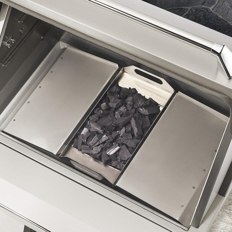 Pellet hopper drawer with dark pellets inside, visible in open smoker body