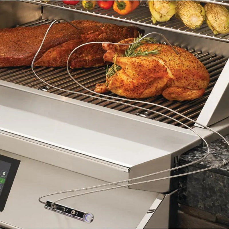 Pellet smoker grill with roasted chicken and vegetables on wire cooking grates