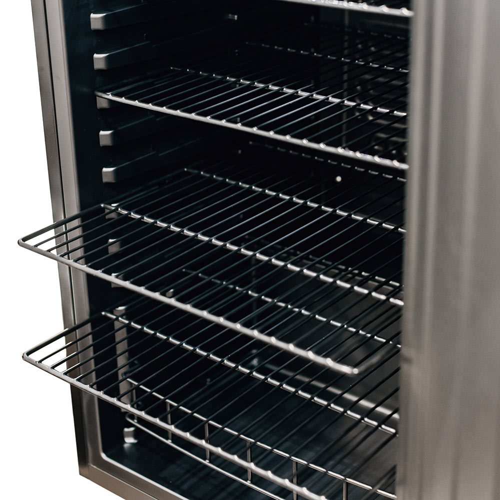 Compact refrigerator interior with black wire racks and metal shelf supports.