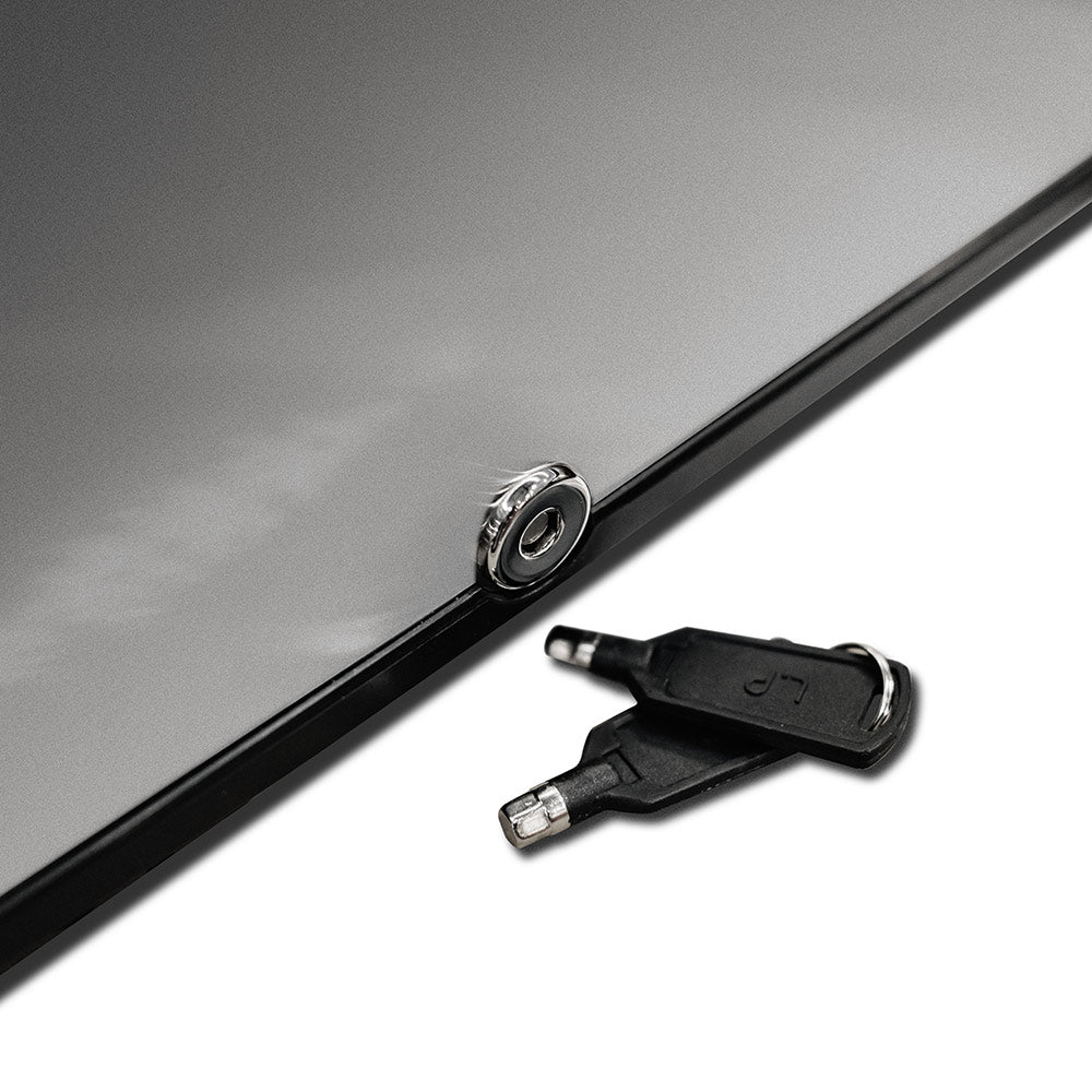 Compact refrigerator door lock cylinder with included key, close-up.