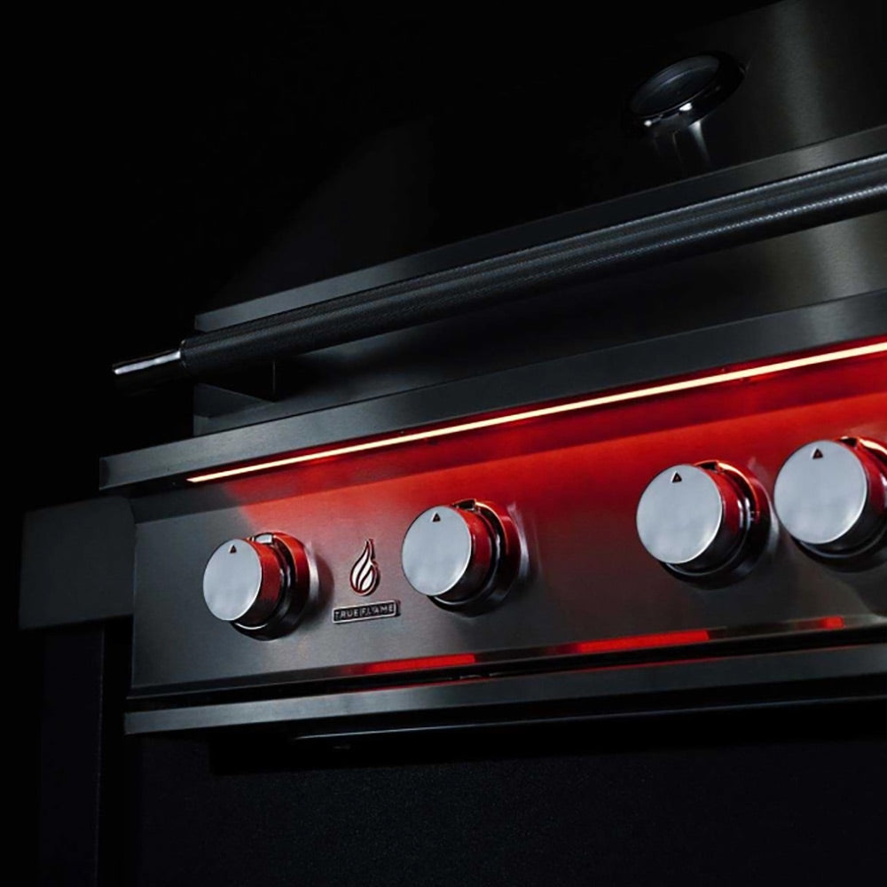 Stainless steel grill control panel with round knobs and burner indicator lights