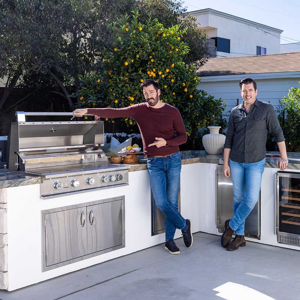 Stainless steel built-in gas grill with control panel on outdoor island setup