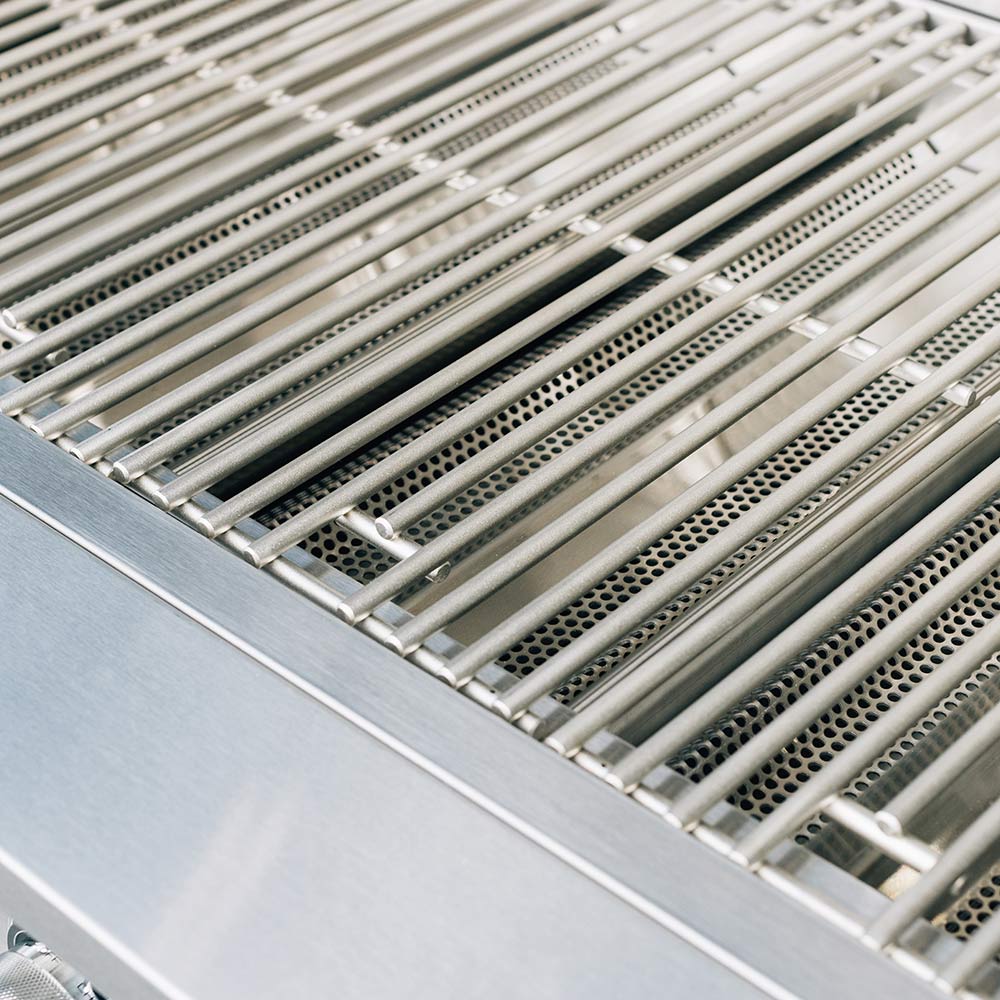 Stainless cooking grates with parallel bars inside a gas grill