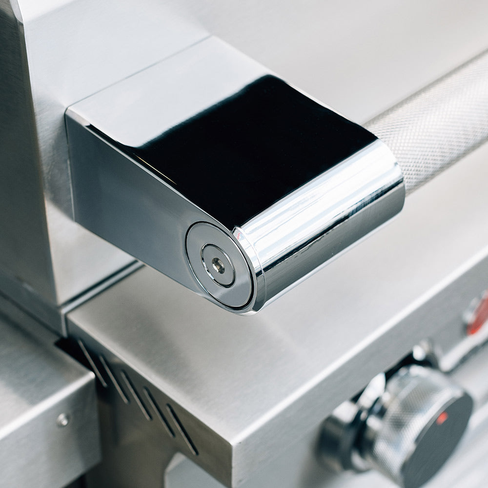 Stainless steel side control housing with round lock knob on a gas grill