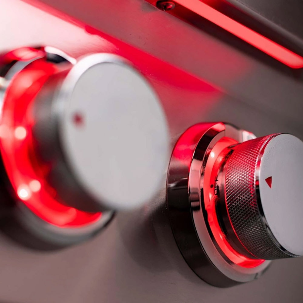 Side burner control knob with red indicator ring and textured grip on stainless panel